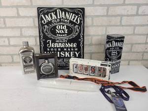 lot 555 image: Lot of Jack Daniels and Jgermeister Items - Stainless Steel Flask, Tin Sign, Playing Card Shot Glasses, Jgermeister Disposable Shot Glasses and More