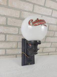 lot 558 image: Cushman Motor Scooter Globe and Cast Iron Light