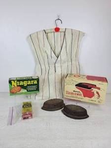 lot 955 image: Lot of Vintage Laundry Items - Clothespin Holder, Sad Irons, RONCO Steam-A-Way Steamer, Niagara Laundry Starch, and More