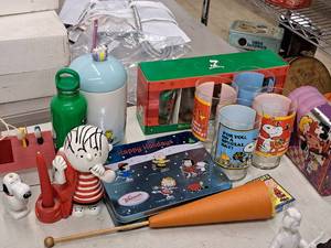 lot 164 image: Lot of (14) Peanuts Collection - Linus and Snoopy Electric Toothbrush, Collectors Glasses and Tins, Water Bottle, Playing Cards and more