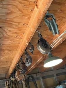 lot 65 image: Amazing Vintage Heavy Duty Cast Iron and Wood Barn Pulley Lot (8 Pulleys Total)