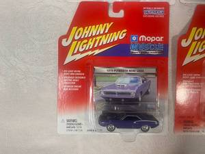 lot 24 image: Four new in package Johnny Lightning Diecast Car
