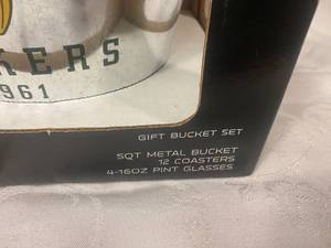 lot 89 image: Green Bay Packer Gift Bucket Set, Contains 5 QT metal bucket 1961, 12 Coasters, 4-16oz Pint Glasses