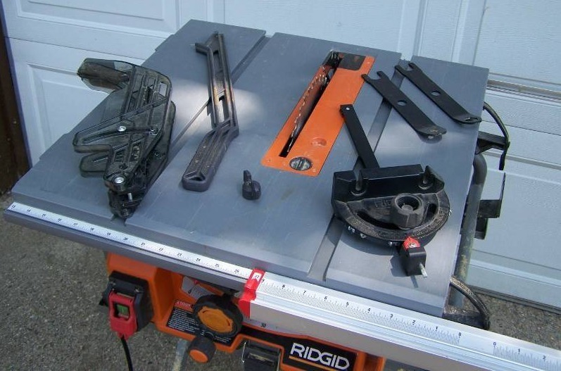 lot 304X image: Ridgid 10 inch table saw and stand, model #R4518T.