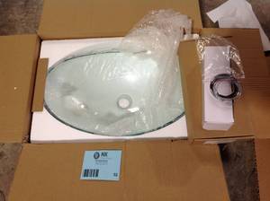 lot 32 image: Glass Oval Vessel Sink in Clear with Faucet Pop Up Drain Set by Puluomis  Customer Returns See Pictures