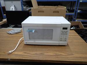 lot 53 image: Microwave  removed from working environment  will need a wipe down