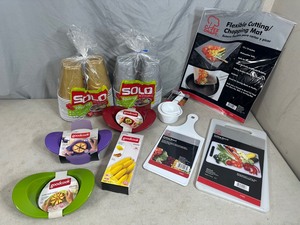 lot 114 image: New Solo Cups, Cutting Boards, Apple Slicers, Orange Slicer, Measuring Cups
