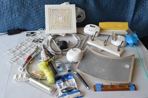 lot 34 image: Fire Alarm, Smoke detector, C02 Detector, twine, Speed crank handle, storage hooks, 3 plug adapters, Sink supply lines and more