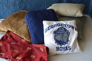 lot 35 image: Velvet brown chenille, hand sewed george town hoyas pillow, tan and teal square and rectangle throw pillows, solid blue throw pillow, 2 red throw pillow cases 18x18