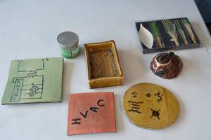 lot 39 image: Hand made, hand carved, ceramic, electrical schematic symbols on pieces. Quail clay figurine. New in box incense sticks and holder.