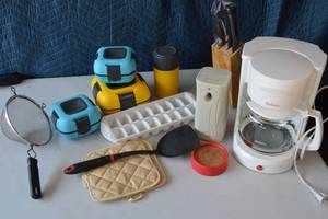 lot 40 image: Sun beam coffee maker, ice cube trays, fryerstrainer scoop, campingon the go tupperware sets, spatula, hot padsoven mitts, Knife set with wooden blockknife block, automatic air freshener dispenser.