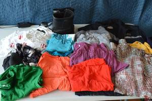 lot 42 image: Winter boots, womens clothes-shirts, dress shirts, casual shirts, pants, variety of colors, name brand JC Pennys brands, sizes L, XL.