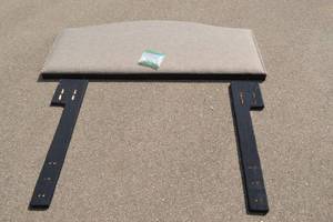 lot 55 image: New grey headboard. retail $200.00, black legs, screws and hardware included. Queen size. Bronzed buttons