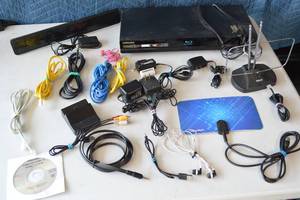 lot 64 image: Assorted Electronics DVD Player, Cables, Phone Chargers, DSL, Internet, Earbuds