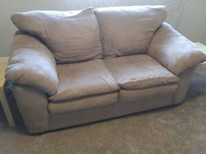 lot 13 image: Matching Microfiber Suede tan Couch & Loveseat. Paid over $1000 new No stains or tears on fabric or cushions, easy to clean. In basement bring help to carry and load.