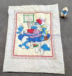 lot 138 image: Vintage Smurfs Quilt And Wind-Up Toy