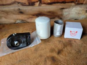 lot 69 image: New Oil Filter Assembly and (2) Evil energy Stainless Steel 2.25 Exhaust Band Clamps