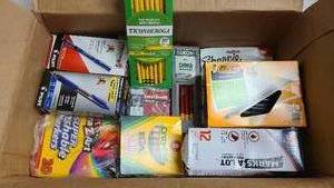 Box full of markers and pens for office and school
