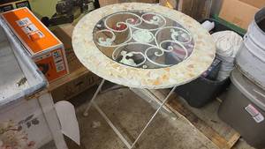 Stone and glass outdoor table with folding metal legs