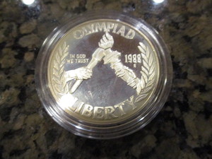 lot 63 image: 1988-S Olympic (Torch Passing) Commemorative Silver Dollar