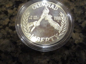lot 64 image: 1988-S Olympic (Torch Passing) Commemorative Silver Dollar