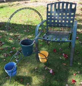 lot 79 image: METAL PLANT STAND WITH METAL LAWN CHAIR.