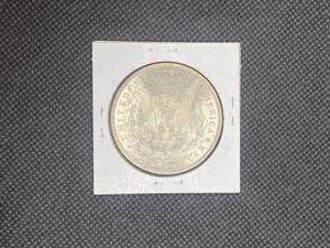 1890 Morgan Silver Dollar marked MS64 when purchased