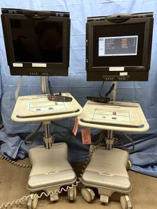lot 27 image: $$$$ Lot of 2 Humanscale Healthcare Point of Care Carts Mobile Standing Desks with Polycom Monitors - Need A Little Clean Up - Monitors Both Work Great - See Pictures Both Come With Their  Remotes
