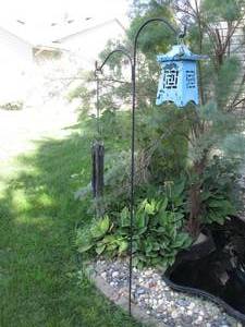 lot 172 image: Shepherds hook with metal candle holder and wind chime