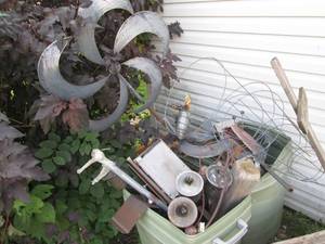 lot 216 image: Large collection of yard decor, tiki torches and more in 2 plastic containers