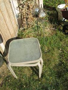 lot 230 image: Pair of metal framed glass top patio side tables with decorative lawn orbs
