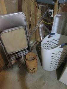 lot 154 image: Corner lot to include Tall Laundry basket with bathroom rugs, Pumpkin themed mini-milk can, folding chairs, wood trim and other Misc