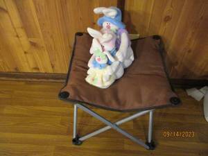 lot 127 image: Fold-up camping seat or table with snow-bunny family