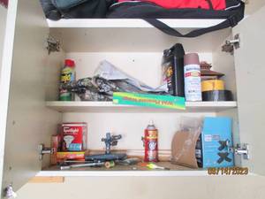 lot 86 image: Content of cabinet to include Bug Fogging liquid,  adhesive tapes and other assorted items
