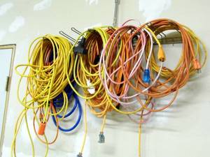 lot 5 image: Huge Assortment of indoor and outdoor extension cords, an air hose, 4-way tire iron and more