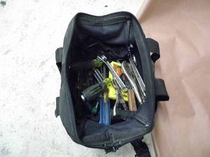 lot 60 image: Tool bag filled with an assortment of hand tools including nut drivers, screwdrivers,  pliers, wrenches,  sledgehammer and more,