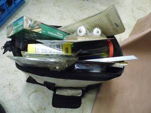 lot 64 image: Masterworks tool bag exploding with a huge variety of new in package hardware, supplies and accessories for the home and shop