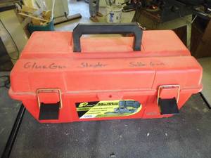 lot 297 image: Plastic toolbox containing a soldering iron, electric staple gun, glue gun plus misc tools, hardware and supplies