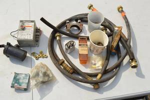 lot 58 image: Supply Lines, Washer Hoses, Honeywell R8184G1427 International Oil Burner Control (retail $140), Compression and Brass Fittings, Gas Train Unions, High Temp Limit Switch, Capacitor, Radiator Vent Keys, Miscellaneous Supplies.