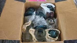 Box full of capacitor glass caps from different time periods