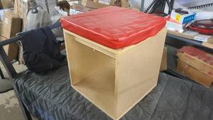 Cube storage seat with red cushion