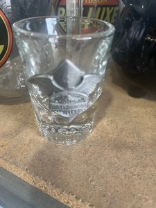 lot 46 image: 2 Harley mugs 2 glasses 1 shot glass 1 cup all Harley Davidson