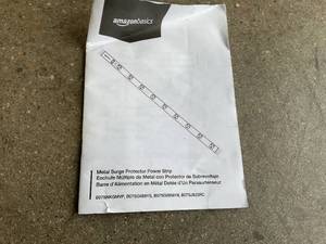 lot 191 image: Amazon Basics Heavy Duty Metal Surge Protector Power Strip with Mounting Brackets - 12-Outlet, 600-Joule (15A OnOff Circuit Breaker)