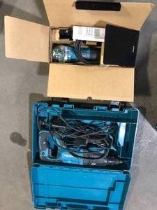 lot 44 image: Makita 8 Amp 1 in. Corded SDS-Plus ConcreteMasonry AVT Rotary Hammer Drill with 4-12 in. Corded Angle Grinder with Hard Case  Customer Returns See Pictures