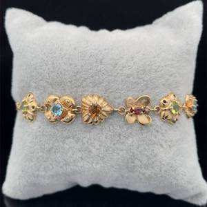 lot 38 image: Natural Semi-Precious Gemstone Heart, Butterfly & Flower Puffed Link Bracelet in 14k Yellow Gold - Peridot, Garnet, Blue Topaz, Citrine $1,950 Retail