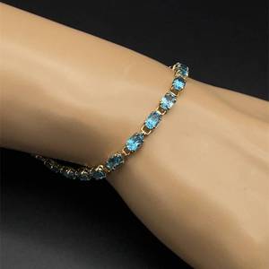 lot 58B image: Oval Natural Blue Topaz Single Row Hinge Link Tennis Bracelet in Yellow Gold  VIDEO 
