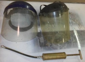 lot 951 image: Grease Gun And Face Shields. (2) Shields, (1) Grease Gun.