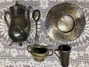 lot 20 image: Assorted Ornate Silver-Plate Serving Pieces - CoffeepotTeapot, Round Serving Platter, Salad Server, Sugarbowl, and Cup with numbers and info on bottom
