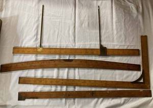 lot 25 image: Four Vintage DressmakersClothiers Wooden Ruled Measuring Tools, 9 Vintage Wood Clothes Hangers including 2 of The Golden Rule, Wicker Basket