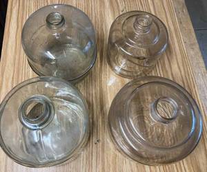 lot 65 image: Four Vintage Glass Kerosene Jugs, Largest Jug is Green Glass with a Spring on Top, Has Chip in the Mouth of the Jug, - Cleveland Metal Products